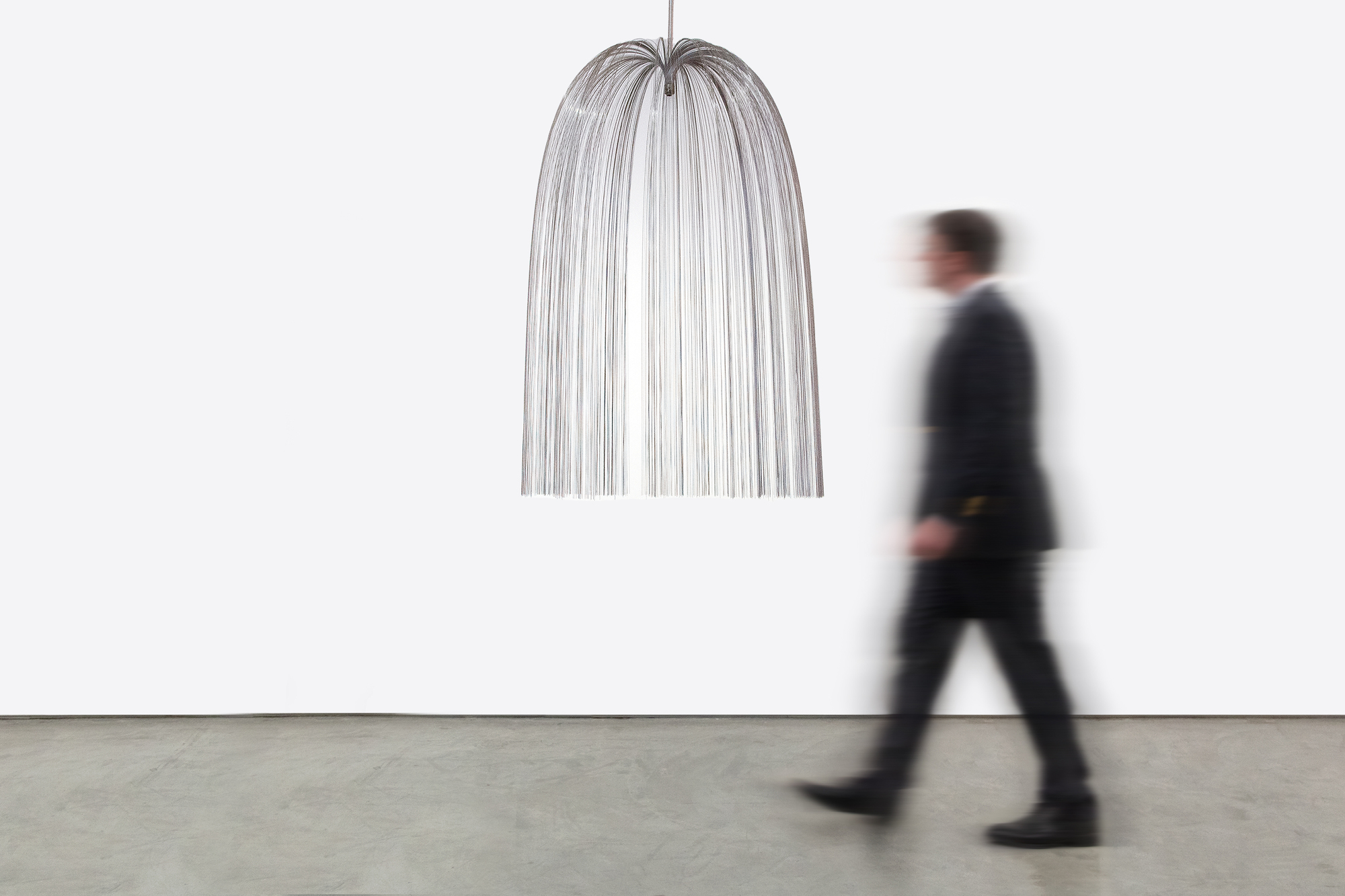 Harry Bertoia’s Willow sculpture resonates as an expression of grace and delicacy; qualities that bely the usual associations we have with the intrinsic properties of the alloy of which it is made. This suspended version – the rare version of Willow - seems to have a self-aware presence; one that delights in that contrast of properties. Yet it invites nothing more than existential pleasure in the viewing of it.  Think of Willow as a boldly articulated version of Calder if the latter master had a more organic or corporeal evocation in mind. Suspended, it commands its area yet respects its spatial relationship to its surround. Light, form, space – these are conceptual tools of the sculptor. But who else would think to use reflective material more readily associated with inflexibility and tensor strength to create a bouquet of cascading strands of stainless steel, suspended in space, flora-like and so gracefully beautiful?
