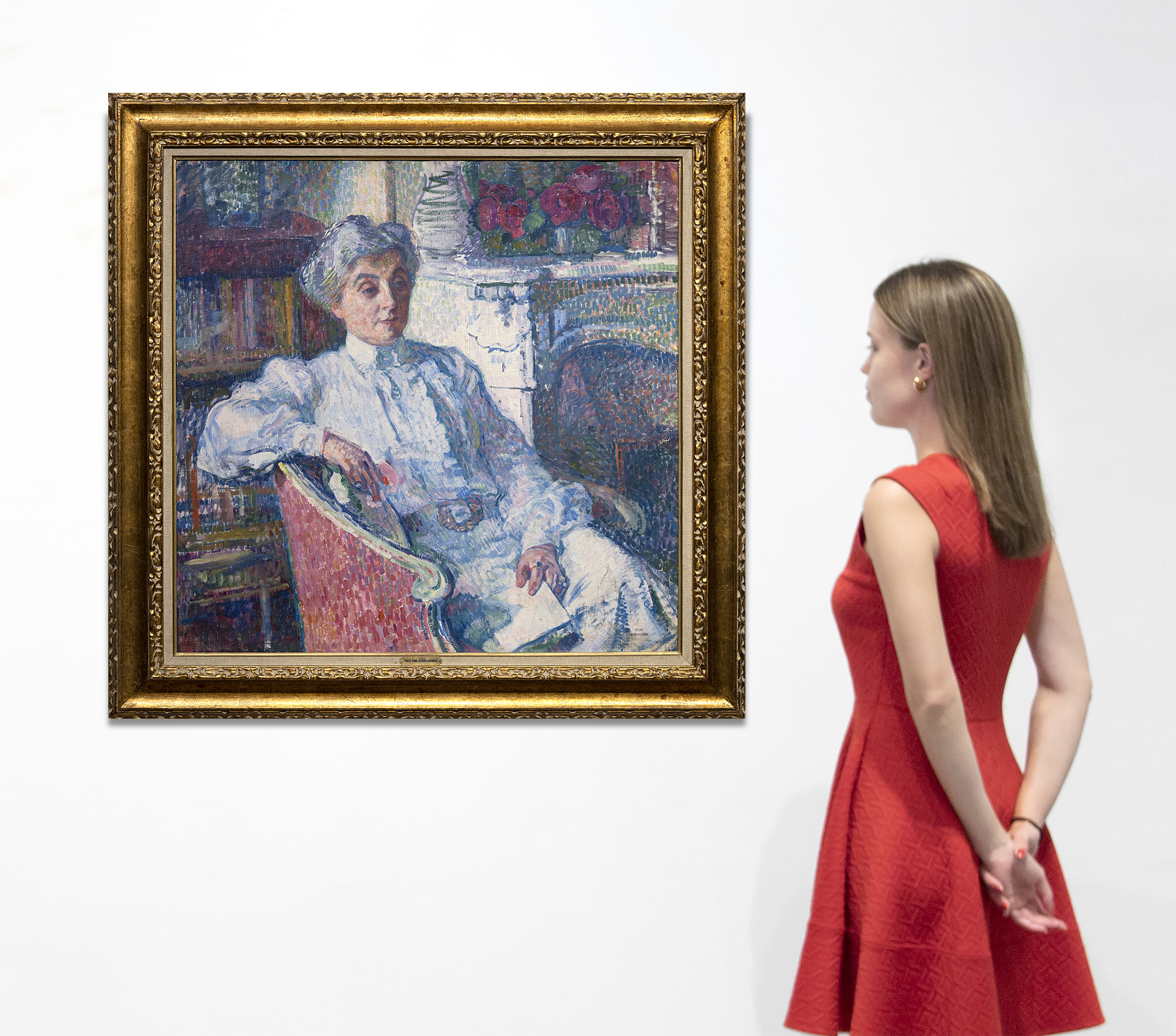 THÉO VAN RYSSELBERGHE - Maria van Rysselberghe au coin du feu An undisputed master of the booming Belgian Neo-Impressionist movement from 1887 onward, Théo van Rysselberghe painted this portrait of his wife, Maria (née Monnom) during the first decade of the twentieth century. He had pressed onward from the influence of Whistler’s Tonalism, Impressionism, and the Pointillism of Seurat to perfect a highly refined understanding of color, its harmonic resonances, and a meticulous rendering of formal elements. An exemplary draftsman, optical impressions based on color interactions remained a principal concern for Van Rysselberghe. Here, short strokes of color replaced the small dots of a Pointillist, and the color scheme is not the homogenized, harmonious one for which the artist has a well-deserved reputation. Rather, this portrait advances color theory in an entirely different manner. Its visual interest rests with the dynamic contrasts of his wife’s silvered coiffure, her platinum-hued dress, and the stark-white fireplace mantle — all staged within the optical vibrancy of the surround dominated by complementary reds and greens. It is a visually stimulating demonstration by a painter who understood the dynamic impact of this unusual color scheme and who arranged the sitter with a strong accent on a diagonal and executed the formula with the craft and agility of a painter in full control of his painterly assets.