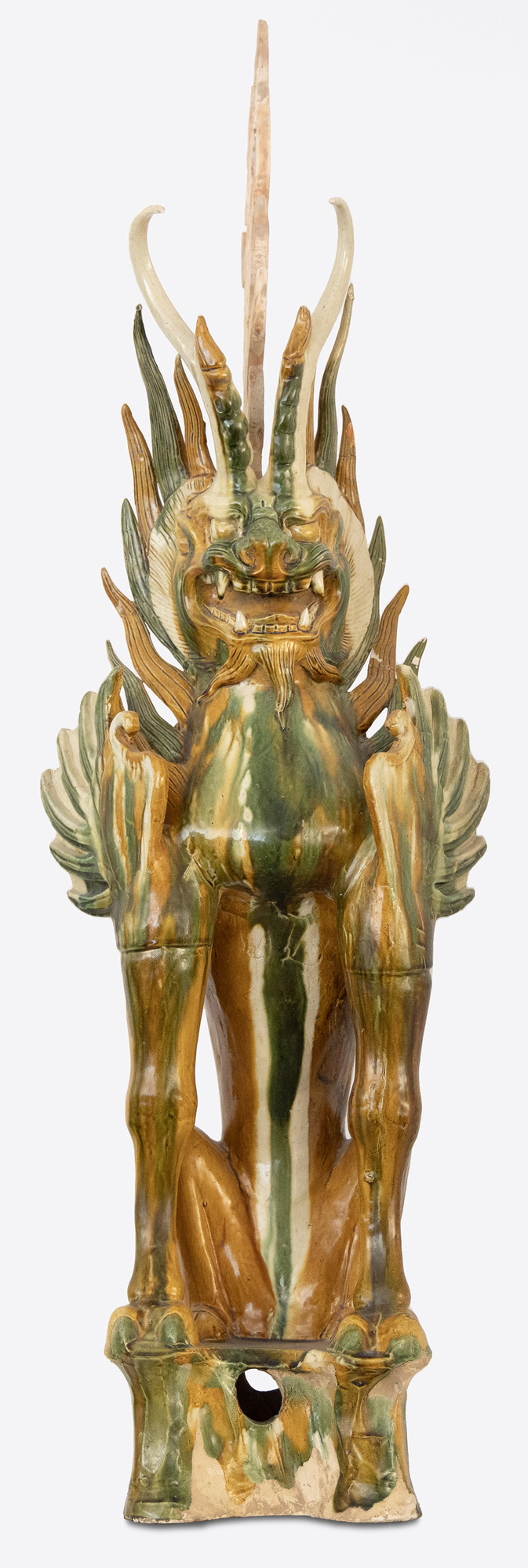 CHINESE - Sancai-Glazed Earth Spirit The Tang Dynasty (618-907 AD) was a prosperous cultural period that helped shape Chinese history's foundations for future centuries. This era was marked by notable technological and cultural advances, including gunpowder and printing. Among artistic advances during this period was the perfection of the sancai glaze technique, which was a prominent attribute of sculpture during this period. Sancai (tri-colored) glazing; the three glaze-colors used were ochre or brown, green and clear. Glazed wares where much more costly to produce than other terracotta wares, and were therefore only reserved for the wealthiest patrons.
<br>
<br>The Sancai-Glazed Earth Spirit offered here depicts a "Zhenmushou." These are mythical hybrid creatures whose bodies are a combination of dogs, lions, boars and other animals. These fierce looking beasts would be found in pairs guarding the entrance of Tang Dynasty tombs.