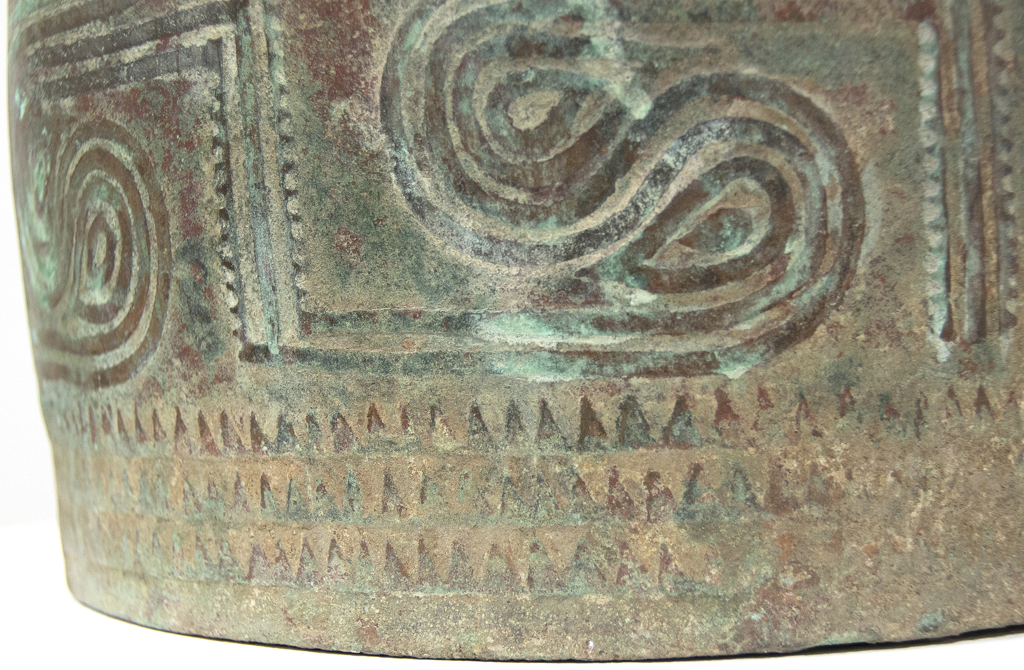SOUTHEAST ASIAN - Thai Bell This well preserved bell is one of the largest known bronzes from the Southeast Asian Bronze Age, generally named after the Dongson site in North Vietnam. The swirling band design is finely and crisply cast. Dongson bronze drums were also reported in South China, Thailand, Laos, West Malaysia, and Indonesia and as Far East as Western Iranian Java. <br><br>The Dong Son culture is a Bronze age culture including all of southeast Asia and into the Indo-Malaya Archipelago from about 1000 to 1 BC. Centered on the Red River Valley of Vietnam, the Dong Son were sophisticated agriculturalists, raising rice and buffalo. Dong Son probably arose from local Neolithic cultures, such as Phung Nguyen and Dong Dau phases. Dong Son is identified with the Van Lang ruling dynasty, the first ruling dynasty of Vietnam. By the second century BC, impacts from the Han Dynasty in China were being felt and according to historic records, the Dong Son were absorbed into the Han Dynasty territory.