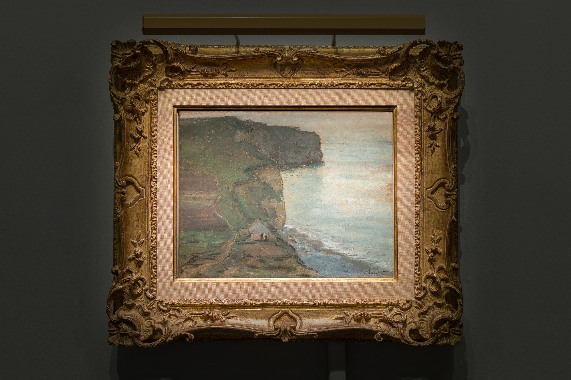 <div><font face=Lato size=3 color="#191919">As the idea of using drawings, whether in pencil or pastel to prepare a painting was at odds with Monet’s publicised creative process, he tended to downplay its importance in his work. However, after his death eight folios containing over four hundred drawings came to light as well as many pastels. This convenient and lightweight medium allowed him to experiment with composition and colour and develop ideas for his oil paintings at speed. He also used pastel to produce finished pictures, as in this example.</font></div><br><br><div><font face=Lato size=3 color="#191919">&nbsp;</font></div><br><br><div><font face=Lato size=3 color="#191919">During the 1880s Monet returned to the Normandy coast. He found inspiration in the sparkling light and famous limestone cliffs, as had Delacroix and Courbet. As well as working directly in oils, he followed Boudin’s example and used black chalk and pastel to study the effects of light and colour on the sky, sea and land.</font></div><br><br><div><font face=Lato size=3 color="#191919">&nbsp;</font></div><br><br><div><font face=Lato size=3 color="#191919">In this seascape at Etretat, twenty miles round the coast to the north of Le Havre, Monet has chosen an unusual composition, dividing the landscape down the centre with the vertiginous cliffs; the left half of the picture composed of earthy greens and browns, the right half a sun dappled sea that dissolves into the sky, the horizon only suggested by the lightest touch of charcoal. This picture has a marked difference in atmosphere to another pastel of the nearby Porte d’Aval, dateable to the same period, whose late afternoon sky shows the range of expression that could be achieved with pastel. By the summer of 1885 the year he made this pastel Monet had largely abandoned urban subjects, and was more drawn towards natural phenomena. He painted many views along the coast under different light conditions. As noted in the catalogue raisonné on Monet, this pastel is not a preparatory study for an oil painting, but a wholly original composition. It demonstrates how well the painter understood and enjoyed the versatility of the medium when trying to capture such variable weather.</font></div>