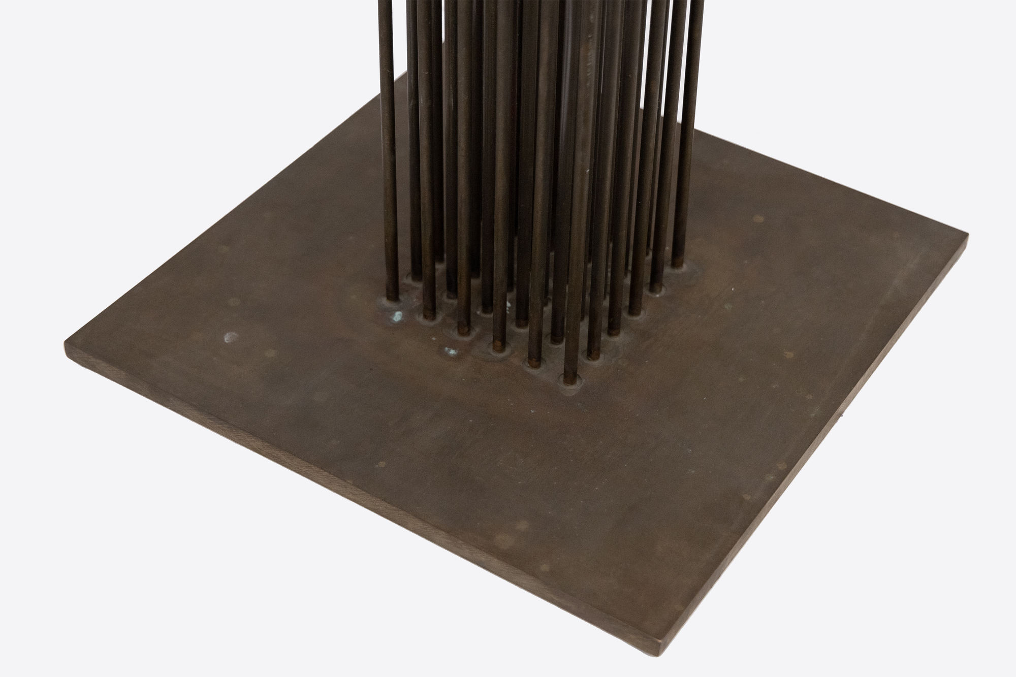 <div><font face=Calibri size=3 color=black>Standing at an impressive 103 inches, this elegantly spare “Sonambient” sculpture by Harry Bertoia allows us to marvel at one of the finest artisans of his generation. This piece, the tallest in the series currently available here at Heather James Fine Art, features a precise arrangement of 36 slender tines in a 6 x 6 grid. This arrangement's uniformity and symmetry are visually captivating and crucial for the sculpture's acoustic properties. The rods, austere and uncapped by finials, have an aged patina with copper undertones, suggesting Bertoia's use of copper or a similar alloy known for its resonant qualities and distinctive coloration. Given the outstanding length of these rods, the attachment method is particularly noteworthy. Bertoia meticulously inserted each rod into individual holes in the base plate using precision drilling and securing techniques such as welding that ensured the rods were firmly anchored and stable, maintaining the structural integrity essential for consistent acoustic performance.</font></div>
<br>
<br><div> </div>
<br>
<br><div><font face=Calibri size=3 color=black>Beyond his uncompromising nature, Bertoia's work draws significant inspiration from natural elements. This sculpture's tall, slender rods evoke images of reeds or tall grasses swaying gently in the wind. This dynamic interaction between the sculpture and its environment mirrors the movement of plants, creating an immersive, naturalistic experience. Yet when activated or moved by air currents, the rods of this monumental work initiate metallic undertones that confirm its materiality without betraying its profound connection to the natural world.</font></div>
<br>
<br><div><font face=Calibri size=3 color=black>Integrating technical precision and natural inspiration depends on exacting construction that ensures durability and acoustic consistency, while its kinetic and auditory nature imbues the piece with a sense of vitality. This fusion invites viewers to engage with the sculpture on multiple sensory levels, appreciating its robust craftsmanship and evocative, naturalistic qualities. Bertoia's ability to blend these elements results in a work that is both a technical marvel and a tribute to the beauty of the natural world.</font></div>