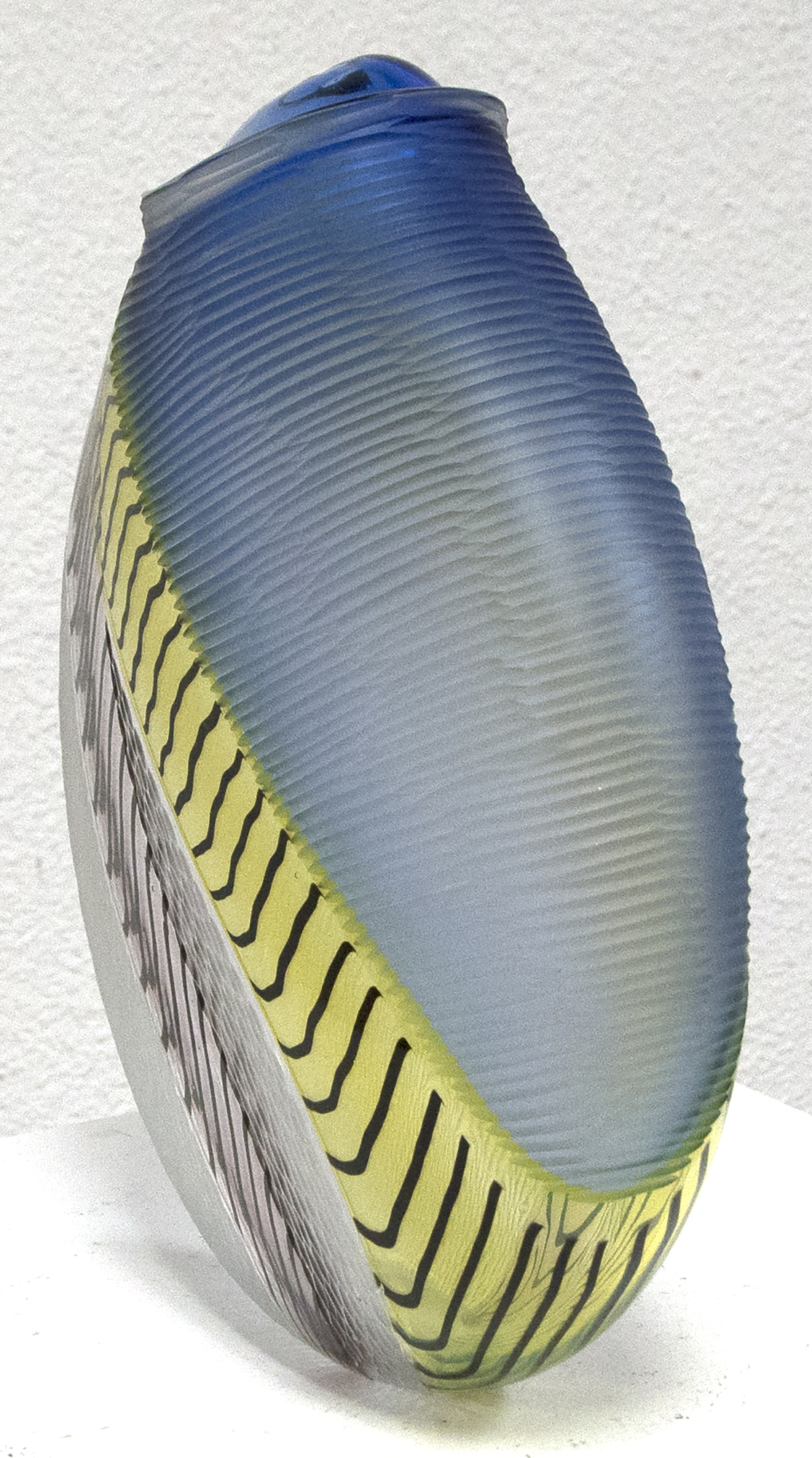 LINO TAGLIAPIETRA - Mandara Hand blown glass with multiple incalmo of colored glass and filligrana. Switching the axel of the glass bubble and adjoining two glass bubbles with raticallo technique. Engraved partially on the surface with different patterns.
<br>
<br>Lino Tagliapietra, a native to Murano, is one of the world's preeminent glass artists.