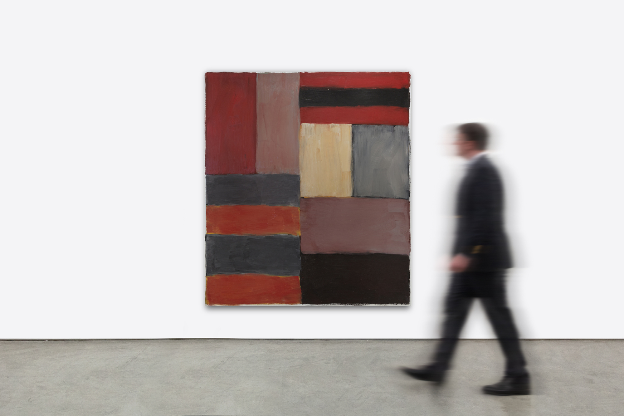 SEAN SCULLY - Grey Red The frame of reference for Irish American Sean Scully’s signature blocks and stripes is vast. From Malevich’s central premise that geometry can provide the means for universal understanding to Rothko’s impassioned approach to color and rendering of the dramatic sublime, Scully learned how to condense the splendor of the natural world into simple modes of color, light, and composition. Born in Dublin in 1945 and London-raised, Scully was well-schooled in figurative drawing when he decided to catch the spirit of his lodestar, Henri Matisse, by visiting Morocco in 1969. He was captivated by the dazzling tessellated mosaics and richly dyed fabrics and began to paint grids and stipes of color. Subsequent adventures provided further inspiration as the play of intense light on the reflective surfaces of Mayan ruins and the ancient slabs of stone at Stonehenge brought the sensation of light, space, and geometric movement to Scully’s paintings. The ability to trace the impact of Scully’s travels throughout his paintings reaffirms the value of abstract art as a touchstone for real-life experience.<br><br><br>Painted in rich, deep hues and layered, nuanced surfaces, Grey Red is both poetic and full of muscular formalism. Scully appropriately refers to these elemental forms as ‘bricks,’ suggesting the formal calculations of an architect. As he explained, “these relationships that I see in the street doorways, in windows between buildings, and in the traces of structures that were once full of life, I take for my work. I use these colors and forms and put them together in a way that perhaps reminds you of something, though you’re not sure of that” (David Carrier, Sean Scully, 2004, pg. 98). His approach is organic, less formulaic; intuitive painter’s choices are layering one color upon another so that contrasting hues and colors vibrate with subliminal energy. Diebenkorn comes to mind in his pursuit of radiant light. But here, the radiant bands of terracotta red, gray, taupe, and black of Grey Red resonate with deep, smoldering energy and evoke far more affecting passion than you would think it could impart. As his good friend, Bono wrote, “Sean approaches the canvas like a kickboxer, a plasterer, a builder. The quality of painting screams of a life being lived.”