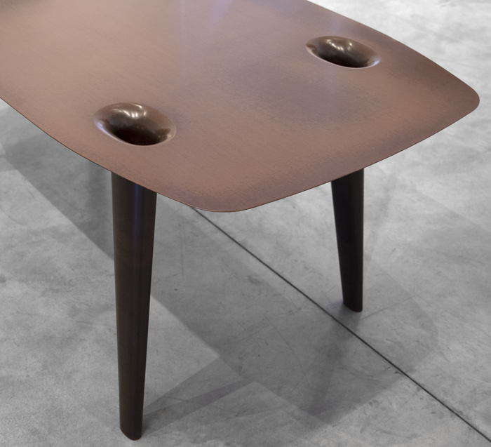 MARC NEWSON - Micarta Table Marc Newson is widely recognized as one of the most influential designers of our time. His subjects range from seemingly ordinary objects such as bicycles to groundbreaking designs in furniture and airplanes. The Philadelphia Museum of Art's 2013-2014 exhibition "Marc Newson: At Home" exposed a new American audience to Newson's futuristic aesthetic in a traditional museum setting.
<br>
<br>"Micarta Table" (2007) uses contemporary materials, including plastic composites, to create the illusion of a traditional wood veneer surface. This blending of old and new is a hallmark of Newson's work. Examples of Newson's work can be found in museum collections worldwide, including the Museum of Modern Art, New York, The San Francisco Museum of Modern Art, and the Cooper Hewitt Smithsonian Design Museum, New York City.