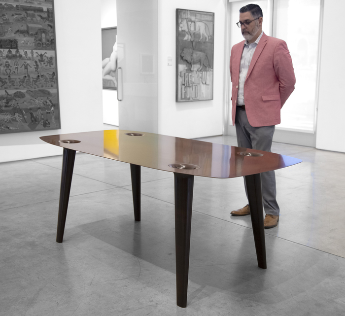MARC NEWSON - Micarta Table Marc Newson is widely recognized as one of the most influential designers of our time. His subjects range from seemingly ordinary objects such as bicycles to groundbreaking designs in furniture and airplanes. The Philadelphia Museum of Art's 2013-2014 exhibition "Marc Newson: At Home" exposed a new American audience to Newson's futuristic aesthetic in a traditional museum setting.
<br>
<br>"Micarta Table" (2007) uses contemporary materials, including plastic composites, to create the illusion of a traditional wood veneer surface. This blending of old and new is a hallmark of Newson's work. Examples of Newson's work can be found in museum collections worldwide, including the Museum of Modern Art, New York, The San Francisco Museum of Modern Art, and the Cooper Hewitt Smithsonian Design Museum, New York City.