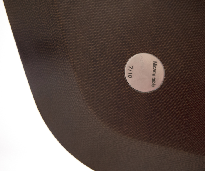 MARC NEWSON - Micarta Table Marc Newson is widely recognized as one of the most influential designers of our time. His subjects range from seemingly ordinary objects such as bicycles to groundbreaking designs in furniture and airplanes. The Philadelphia Museum of Art's 2013-2014 exhibition "Marc Newson: At Home" exposed a new American audience to Newson's futuristic aesthetic in a traditional museum setting.
<br>
<br>"Micarta Table" (2007) uses contemporary materials, including plastic composites, to create the illusion of a traditional wood veneer surface. This blending of old and new is a hallmark of Newson's work. Examples of Newson's work can be found in museum collections worldwide, including the Museum of Modern Art, New York, The San Francisco Museum of Modern Art, and the Cooper Hewitt Smithsonian Design Museum, New York City.