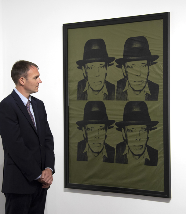 Although the Warhol of the 1980s is associated with excess and celebrity, the decade was perhaps one of his most insightful into fame, infamy, art, and society. The Pop provocateur produced, at an astonishing rate, works that mined these themes. This work featuring a repeated portrait of German artist Joseph Beuys was most likely based off a single Polaroid that Warhol took of Beuys in 1979.<br><br>Joseph Beuys was one of the most important contemporary artists whose work expanded the meaning of art through his performances and unconventional artworks that incorporated unusual but pointed material.<br><br>This piece represents the meeting between Beuys and Warhol, the union of two titans of art coming from a distinctly European and American point of view. Both artists shared an admiration for each other despite their different approaches to art. What the two shared was the ability to reflect society back onto itself and their ability to self-mythologize.