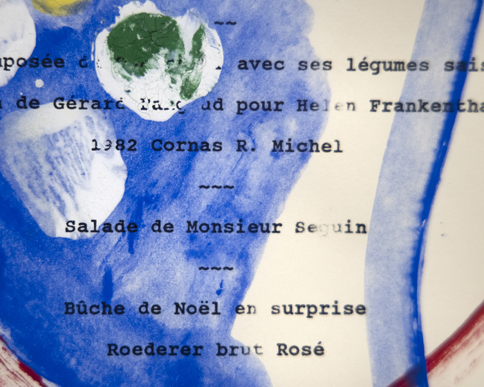 HELEN FRANKENTHALER - Menu from Hans Namuth's Dinner Party Helen Frankenthaler was one of the most important members of the Abstract Expressionists and pioneer within the Color Field movement. Her facility to control paint to stain unprimed canvas allowed her to explore the possibilities of texture, color, and composition.
<br>
<br>Despite the free-flowing nature of her canvas, this small piece shows Frankenthaler’s skill with composition, showing a sense of intimacy and immediacy through its repurposing of a menu. The work does not completely obscure the text but rather incorporates and interacts with it from the field of blue to the meditative red circle to the dabs of white, green, and yellow. Hans Namuth was a German photographer who captured Jackson Pollock and other Abstract Expressionist painters. A photograph by Namuth of Frankenthaler is in the National Portrait Gallery (Washington, DC).