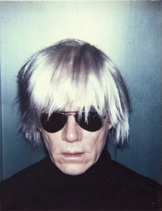Because Warhol was concerned about hair loss, no prop was more critical in crafting his public persona than a wig. Wigs provided his signature look and are an extension of his interest in transformation, performance, and the fluidity of identity. The fright wigs, with their tousled, unkempt appearance, add an element of wildness and eccentricity to Warhol's look. But here, the wig cascades down in a straight, helmet-like coiffure that evokes a more severe and formidable nature. All wigs, for Warhol, provided an opportunity for theatrical role-playing and reflect his fascination with artificiality and self-invention.