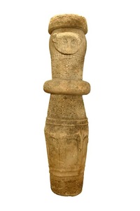Cylindrical offering posts, ai tos, are erected as offerings to distant ancestors. This post has two faces and represents the first ancestral pair. The people of Belu, also called Tetum, recognize three types of offering pole; ai tos, for distant progenitors, sometimes described as gods; foho, for intermediary beings; and lor, for the recently deported.
<br>
<br>Many offerings are brought to the ai tos. When a carving is first finished, rice and a pig are sacrificed. Later, to inaugurate the post there are massive offerings from the village. At regular intervals the post is dressed in fine clothing, even an artificial beard, and food is brought to the ancestor, bei.